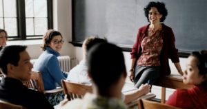 female professor talking with students.