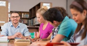 professor with students in library