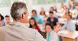 College professor speaking with students