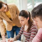 female professor helping students