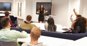 University students study in classroom with female lecturer