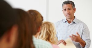 Male professor talking with students