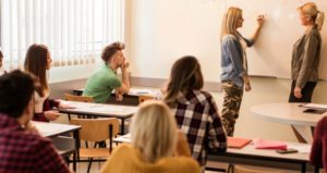 students working in whiteboard on first day of class