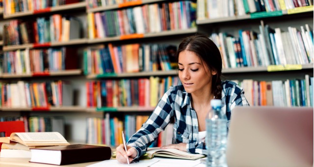 Student working on assignment at library.