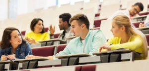 Students engaged in small group discussion in a lecture hall