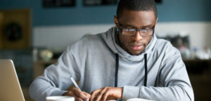 A hardworking student in a coffee shop reflects on his learning