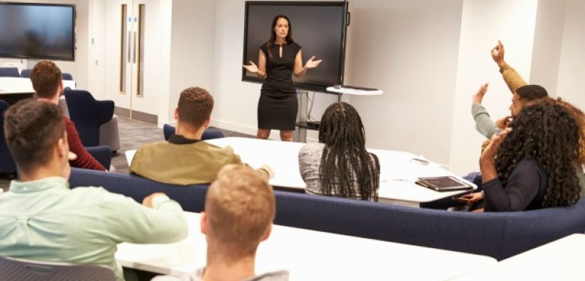 University students study in classroom with female lecturer
